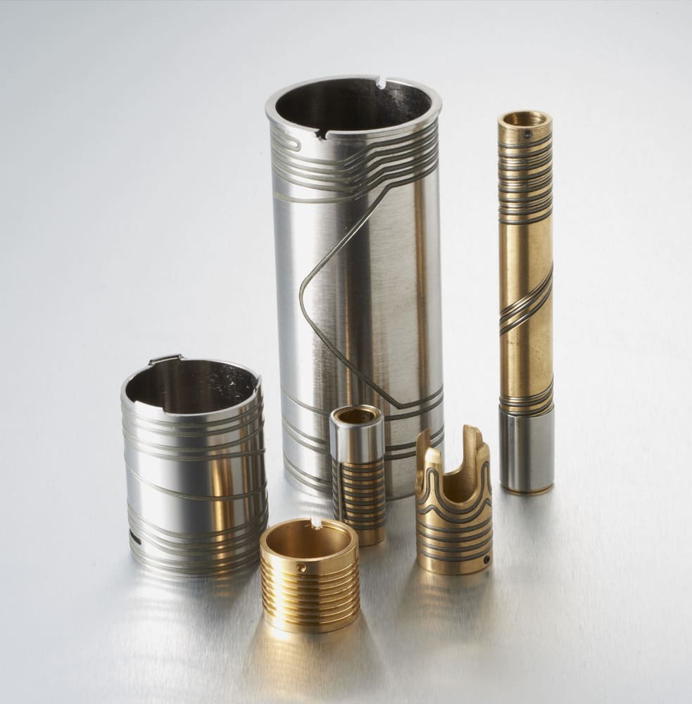 Six cylindrical brass components